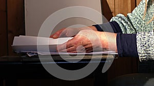 Woman organising paper work and files in office