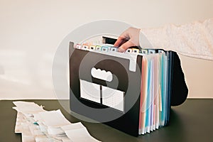 Woman Organizing Documents in a 12-Month Accordion File Organizer