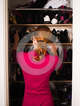 Woman organizing her shoes