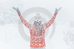 Woman out in the forest with heavy snow falling