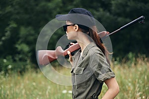 Woman on outdoor Shotgun on shoulder side view hunting lifestyle weapons