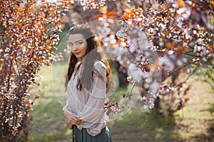 Woman Outdoors in Park Near Spring Blossom Tree