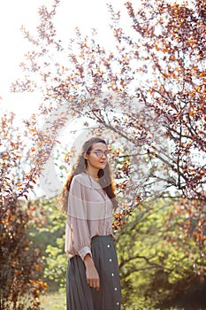 Woman Outdoors in Park Near Spring Blossom Tree