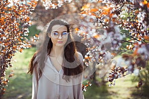 Woman Outdoors in Park Near Spring Blossom Tree