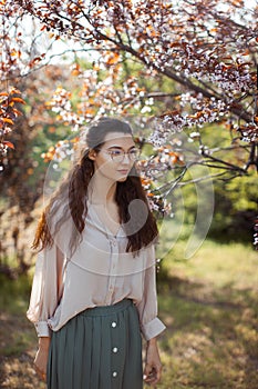 Woman Outdoors in Park Near Spring Blossom Tree