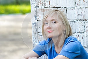 Woman outdoors portrait at white brick wall background