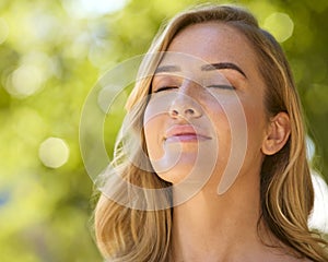Woman Outdoors Relaxing In Countryside Closing Eyes And Breathing Deeply Enjoying Calm Of Nature photo