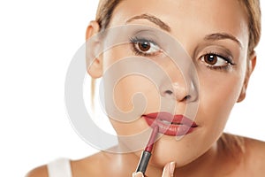 Woman outlining her lips photo