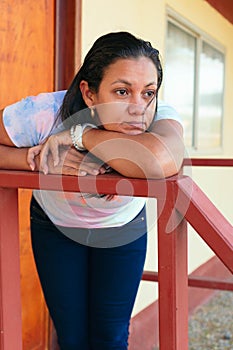 Woman outside her home in thought