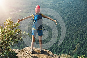 Woman outstretched arms on mountian top photo
