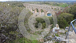 Woman overlooking the ancient Pont du Gard aqueduct