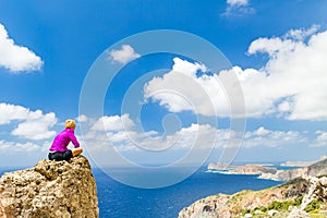 Woman overlooking Mediterranean Sea, Crete Island, Greece photo