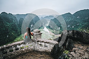 A woman overlooks the mountains of northern Vietnam from Hang Mua, a popular hiking destination.