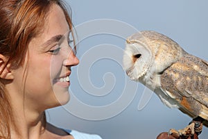 Woman and owl looking each other