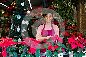 Woman owner flower shop with christmas flower