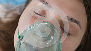 Woman in oxygen mask lying in bed, health problems, depression, fear disease