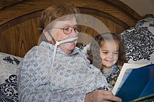 Woman on oxygen reads to child