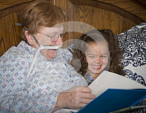 Woman on oxygen reads to little girl