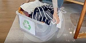 Woman pack box with used clothes for reuse. Reusing, recycling material and reducing waste in fashion, second hand photo