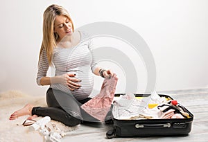 Woman packing baby clothes