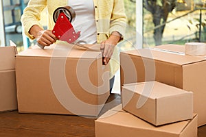 Woman packing box indoors. Moving day