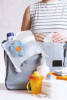 Woman packing diaper bag in maternity hospital.