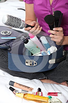 Woman packing her make-up bag