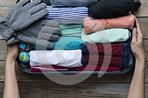 Woman packing a luggage for a new journey