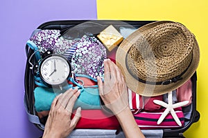 Woman packing a luggage for a new journey