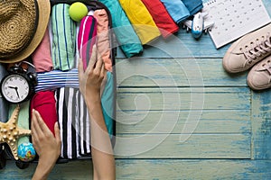 Woman packing a luggage for a new journey