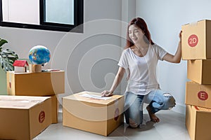 Woman packing to move to a new house. Pack a box on the floor, relocate and move to a new apartment