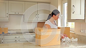 Woman packing up boxes and man moving them