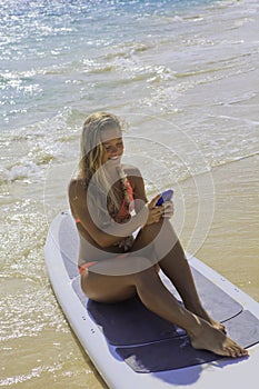 Woman on paddle board texting