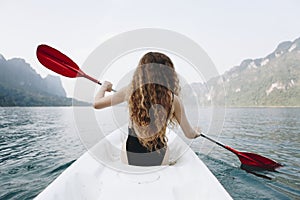 Woman paddling a canoe through a national park