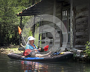 Woman Paddling by Floating Cabin - MorrisonSprings