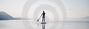 Woman paddling on sup board