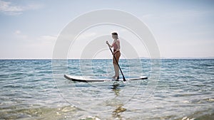 Woman paddling SUP board