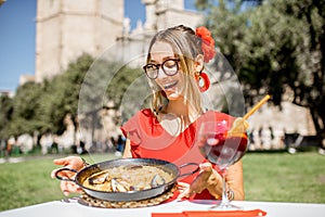 Woman with Paella dish in Valencia