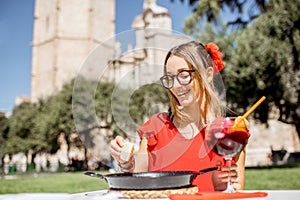 Woman with Paella dish in Valencia