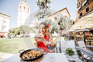 Woman with paella dish in Valencia