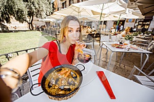 Woman with paella dish in Valencia