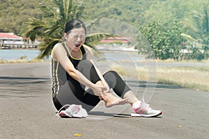 Woman with pain in ankle while jogging