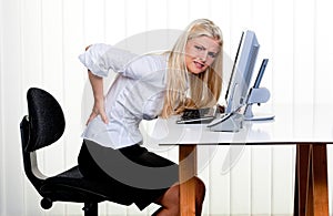 Woman with pain in the back office