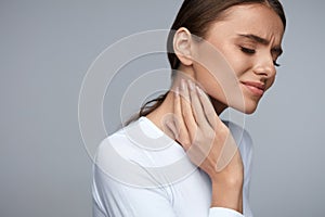 Woman In Pain. Beautiful Girl Feeling Toothache, Jaw, Neck Pain photo