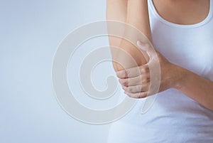Woman with pain in the elbow,Female hand touching her painful elbows