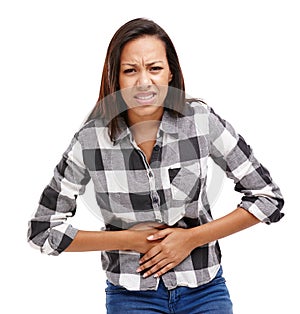 Woman, pain and portrait with hands on stomach, cramp and irritation in white background. Female person, gut health and