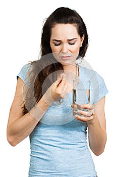 Woman in pain about to take pill.