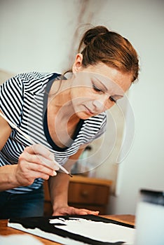 Woman paining on canvas