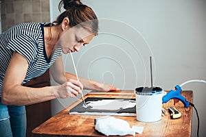 Woman paining on canvas