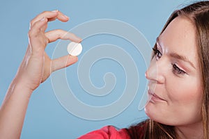 Woman with painkiller pill tablet. Health care.